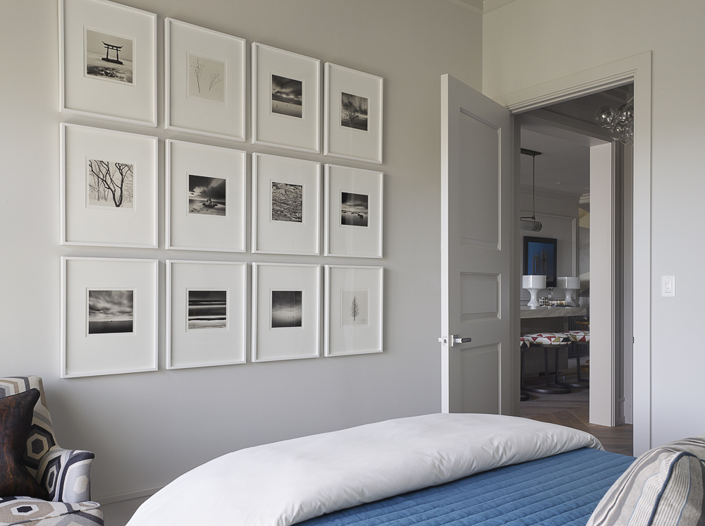 gallery wall in bedroom painted in benjamin moore's gray owl, one of the best neutral colors