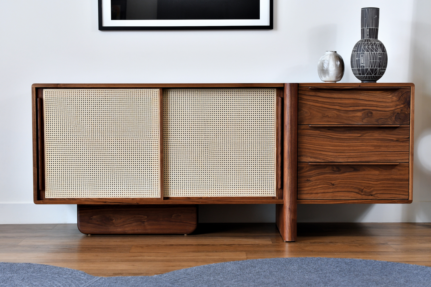 wooden dresser with white-screen sliding doors and two vases on top