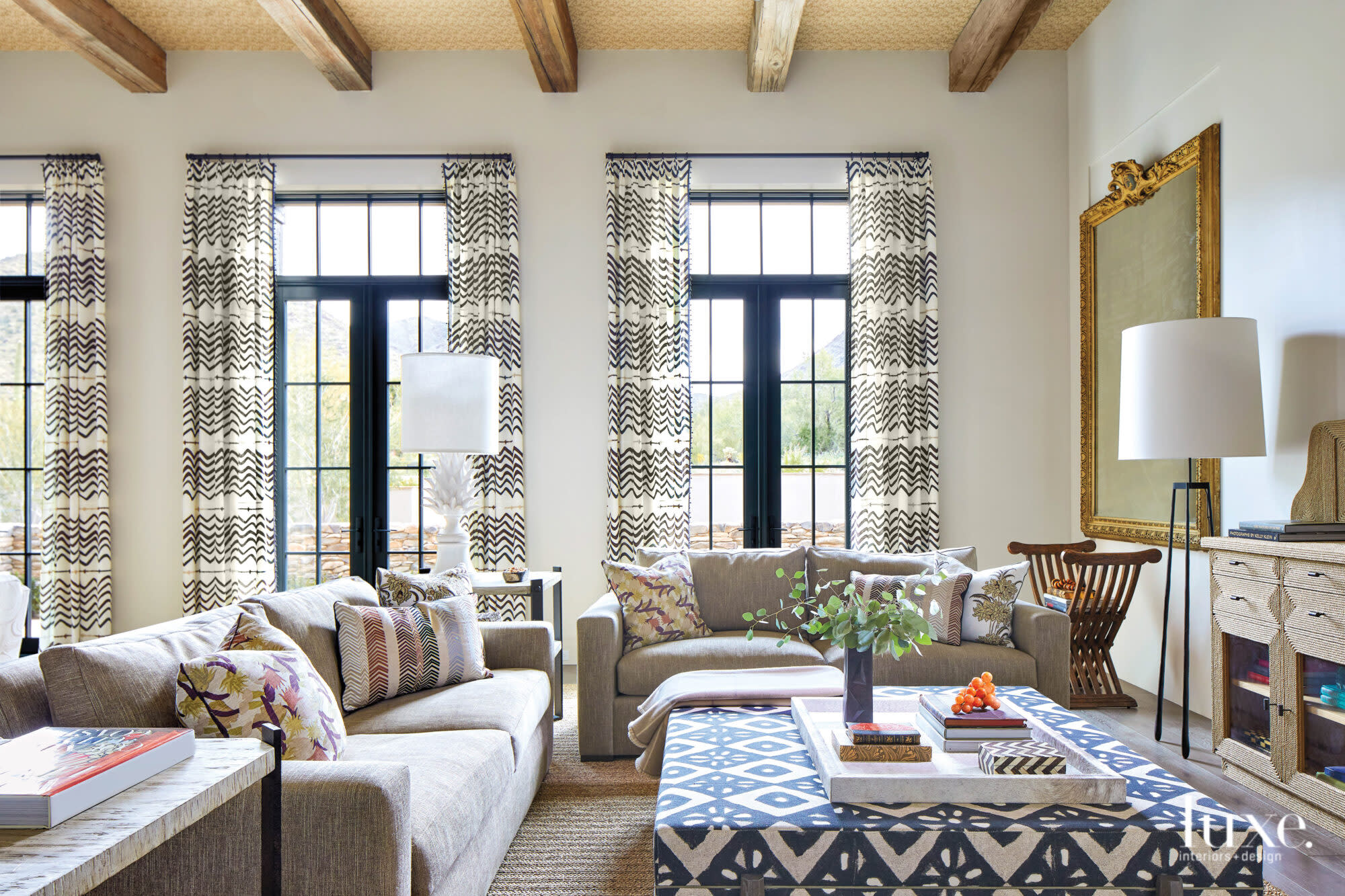 Patterned curtains frame the living room windows