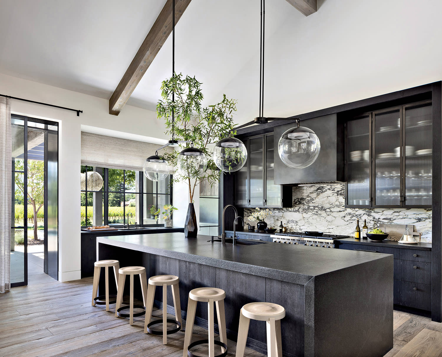 kitchen with black granite countertops accented by a Calacatta Monet marble backsplash