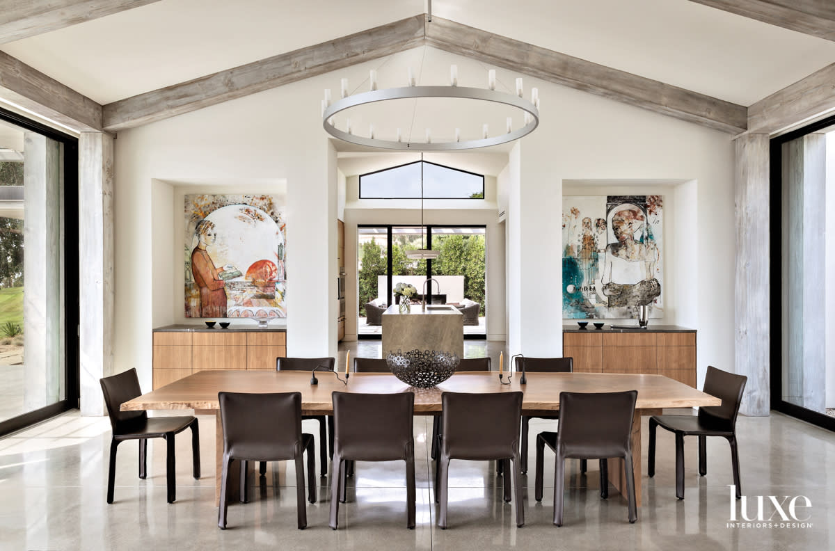 Dining room with table, chairs and two paintings