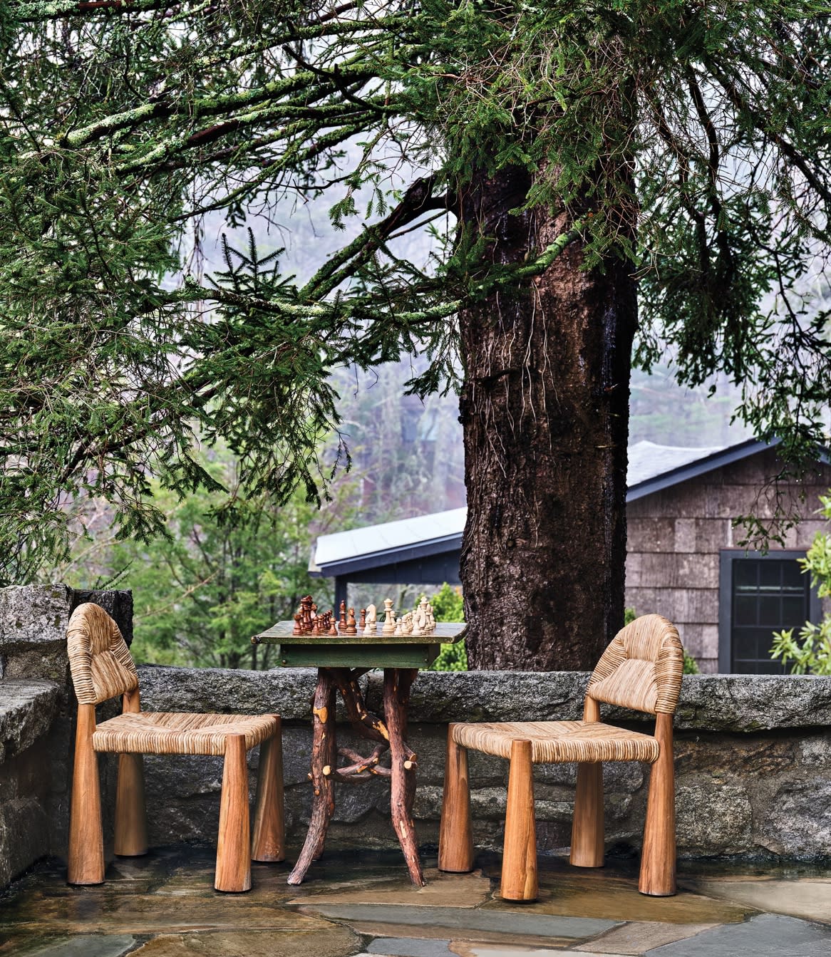 pair of wooden chairs next to a chess table