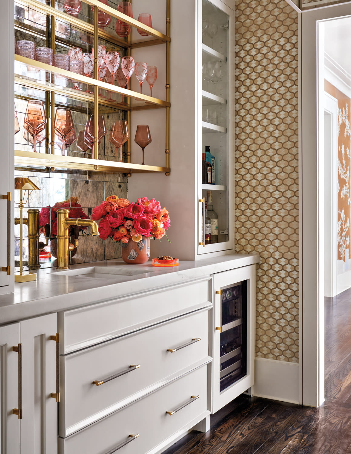 bar area featuring bold wallpaper and an antique mirror backsplash