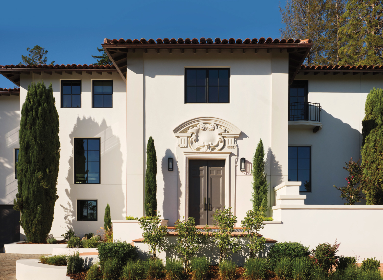 Classic Mediterranean-style home in Hillsborough with a crisp white facade and green plants