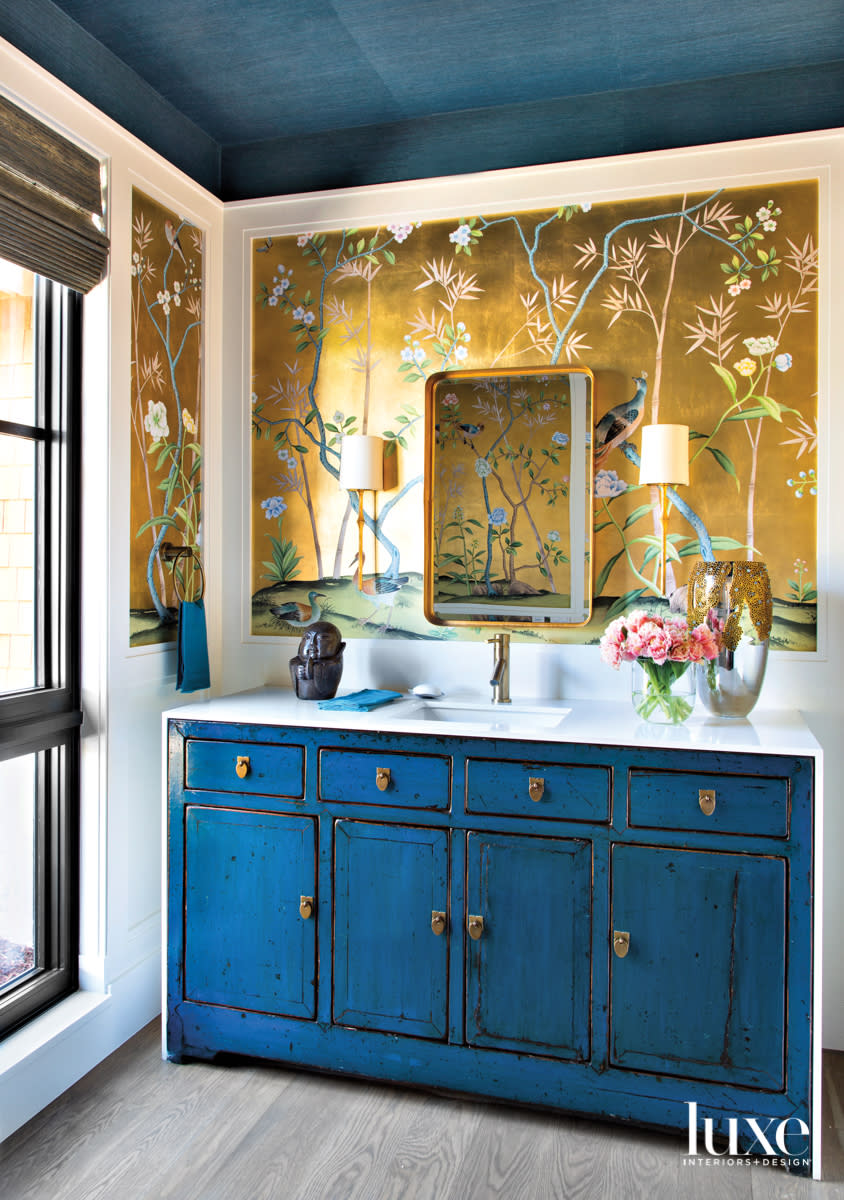 bathroom with blue sideboard and metallic chinoiserie wallpaper