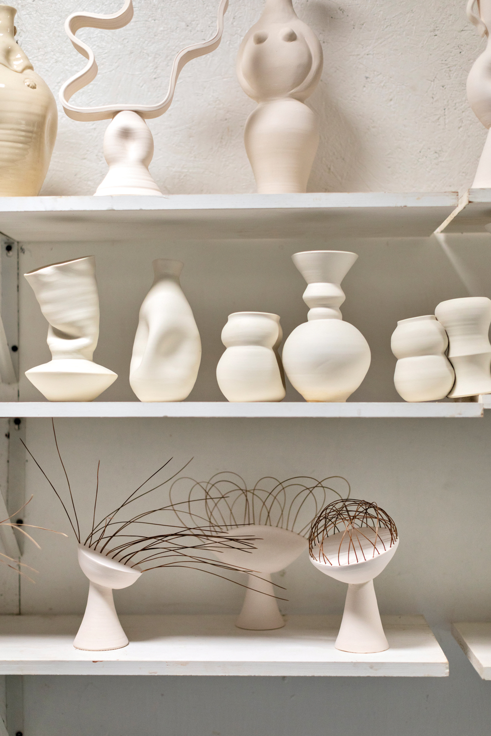 a shelf of anja palombo's sculptures on display in her studio