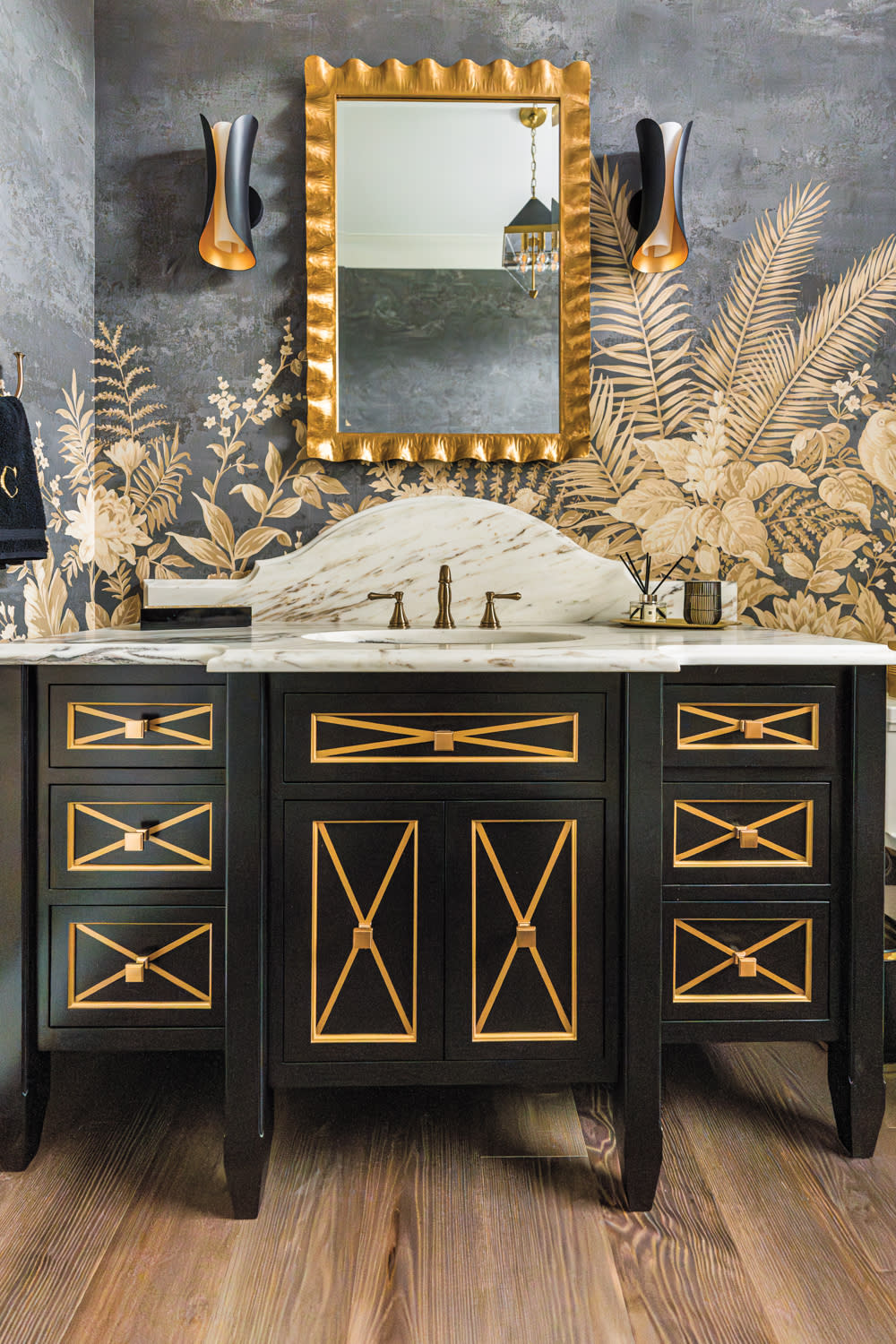 black and gold floral mural above a matching vanity in a jewel box powder room