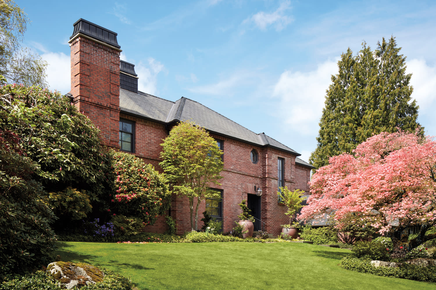 Brick house by Adams Architecture on green lawn