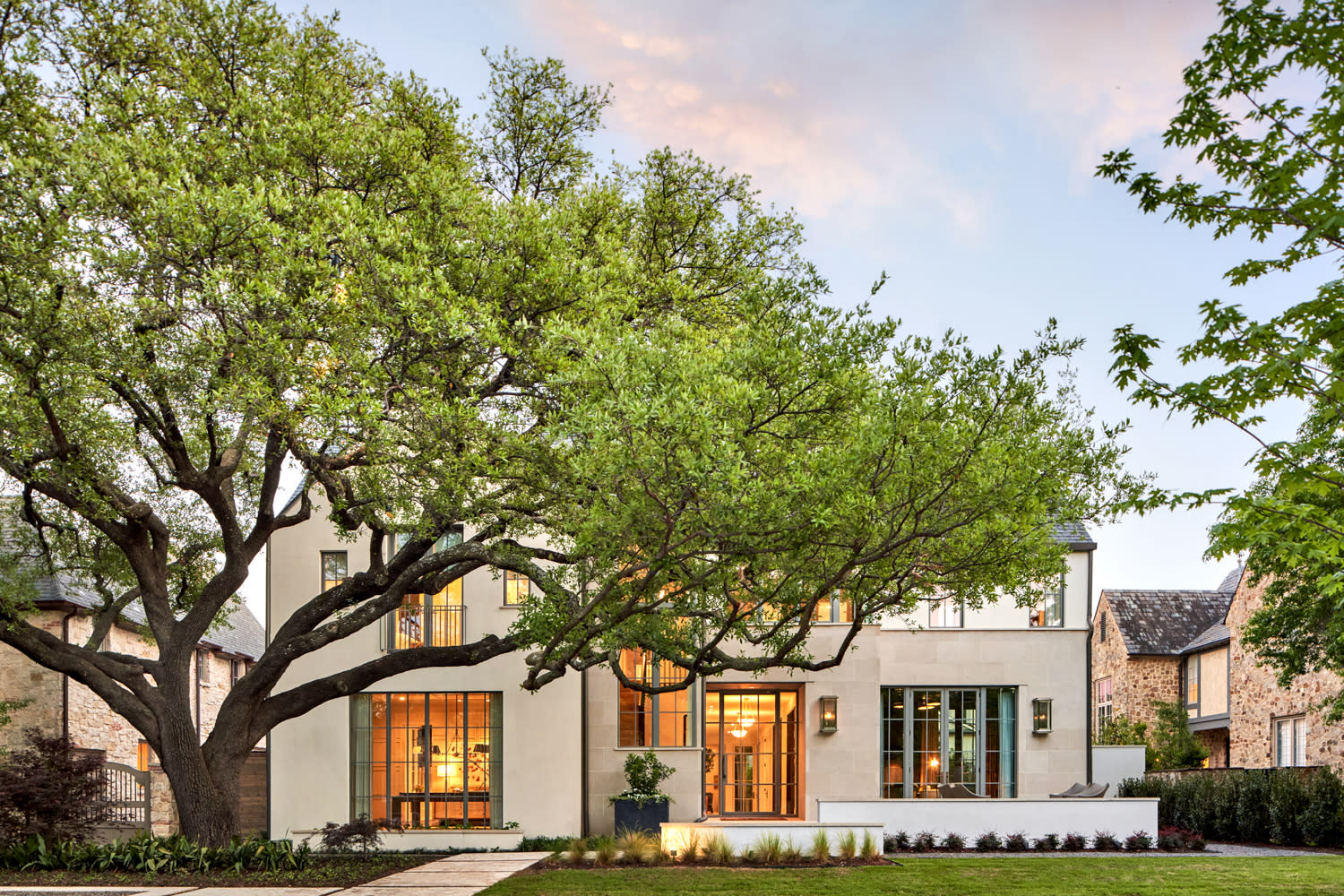 traditional exterior of a Dallas home with a large tree in the front yard