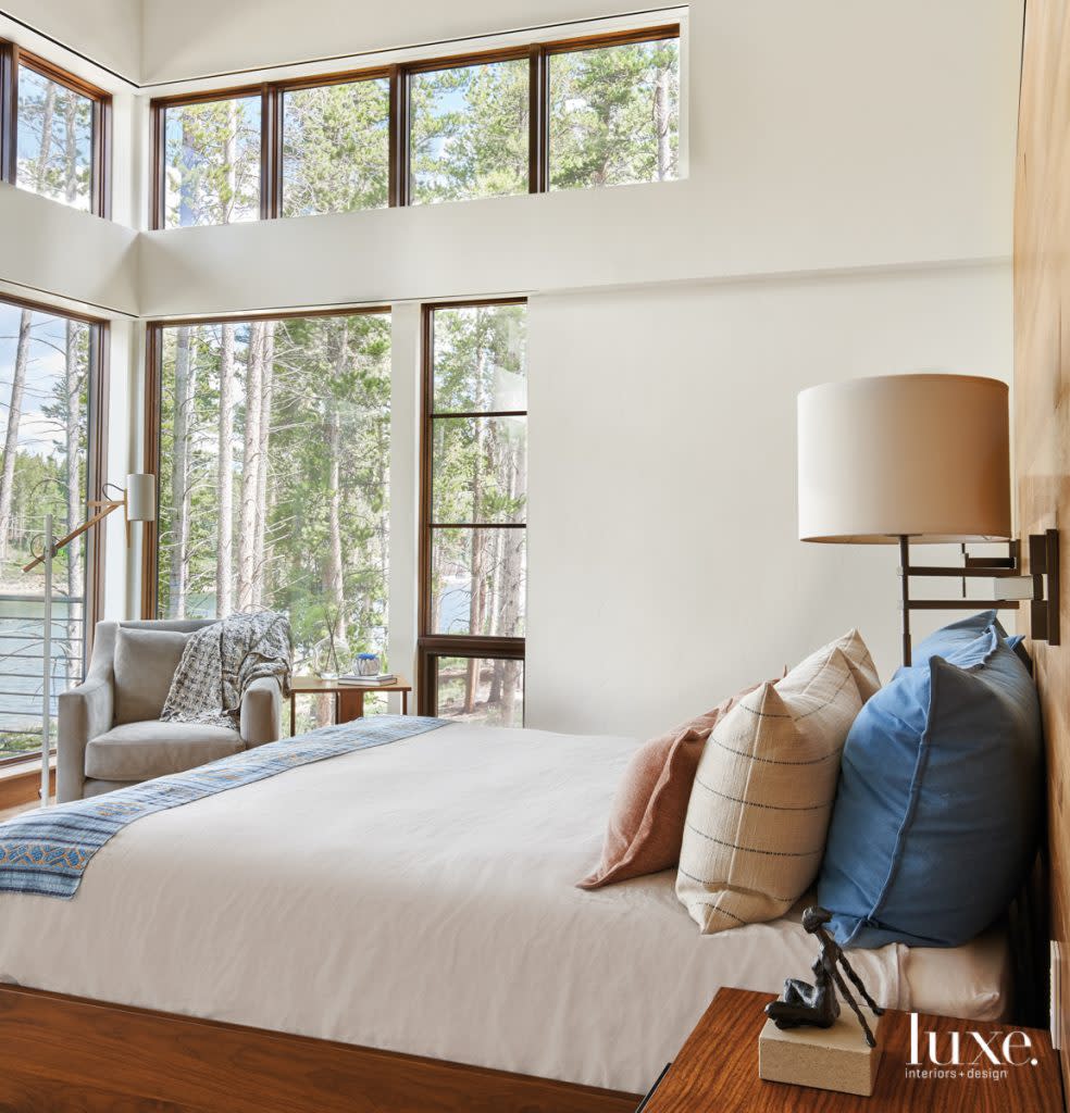 master bedroom with walnut platform bed and blue accents