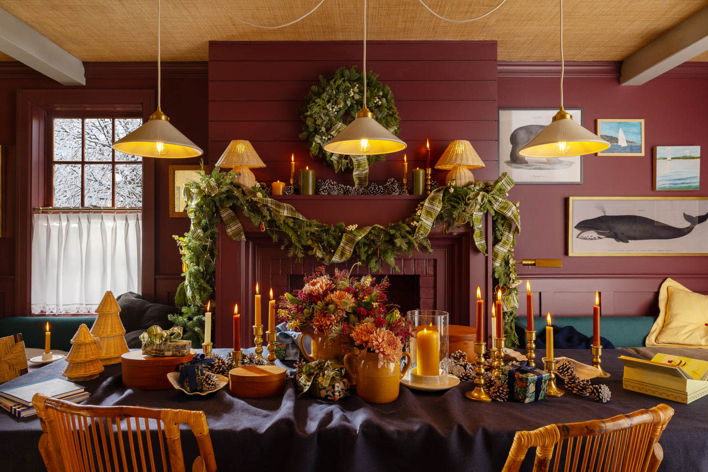 holiday tablescape atop a dining table in a moody red room