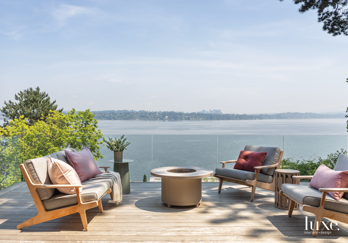 backyard overlooking the lake with glass fence and fireplace