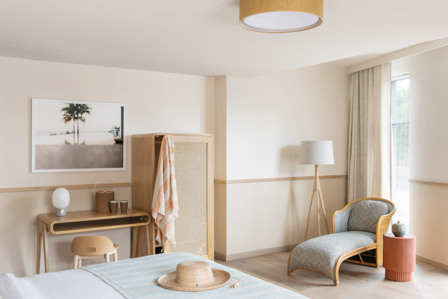 Retro modern hotel room with ivory walls and curvy chaise