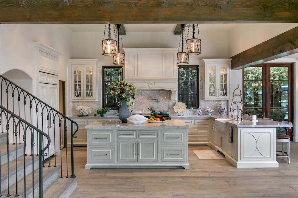 A spacious, modern kitchen with a center island and four pendant lights.