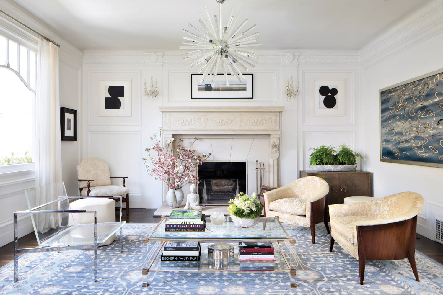 A living room features an ornate fireplace.