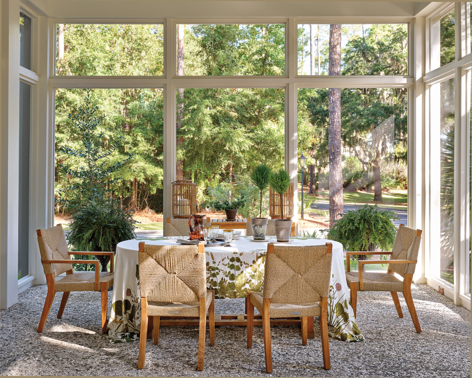 cozy and traditional screened in porch with a dining area
