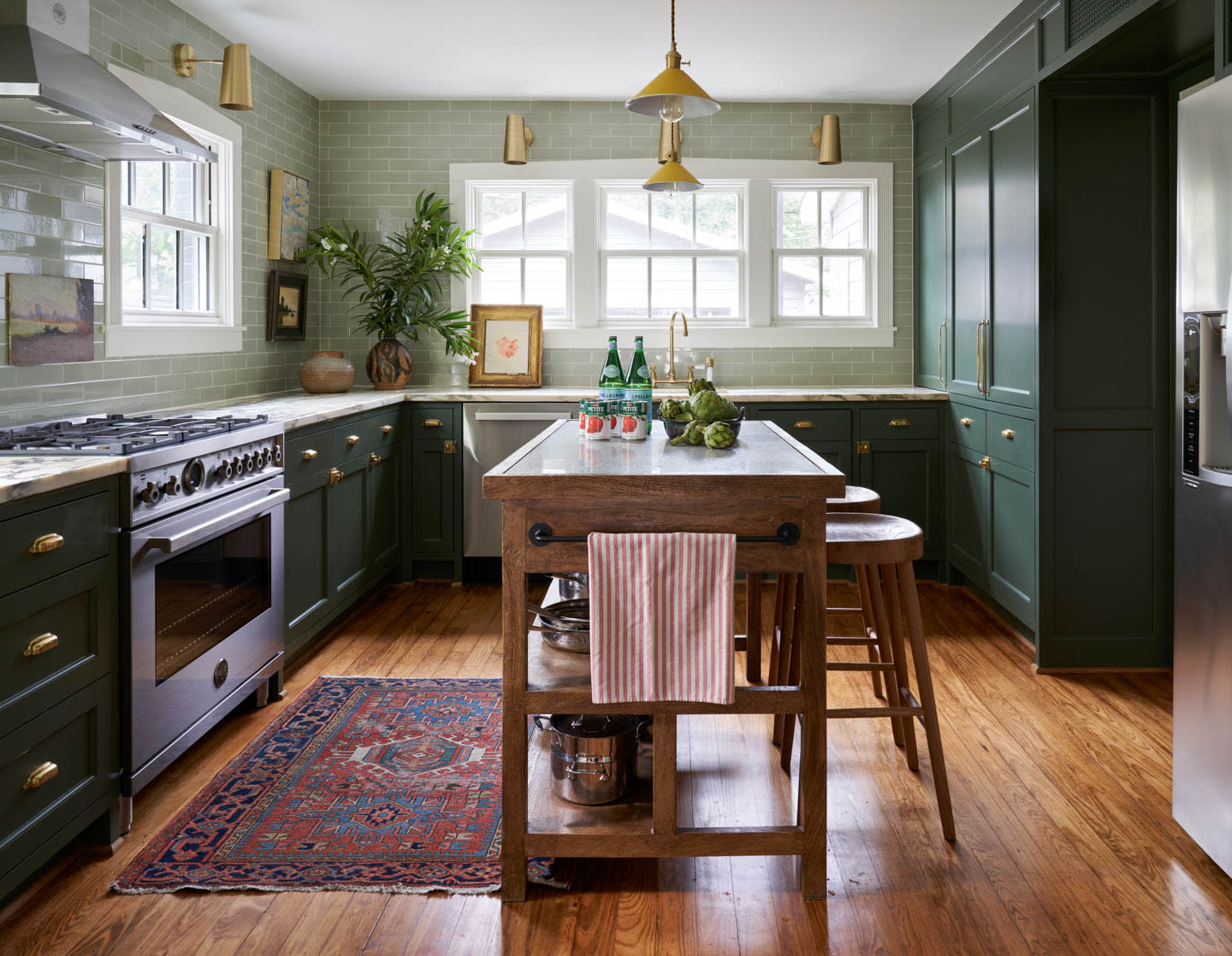 green kitchen with yellow pendant lights