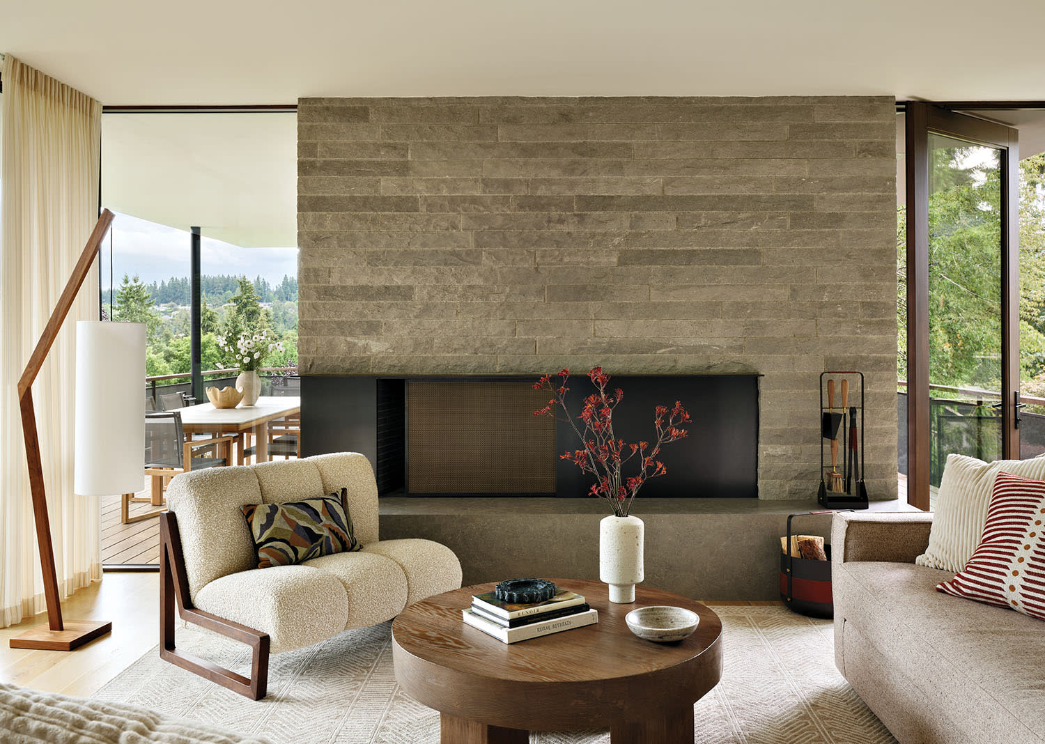 contemporary family room with a stone fireplace wall