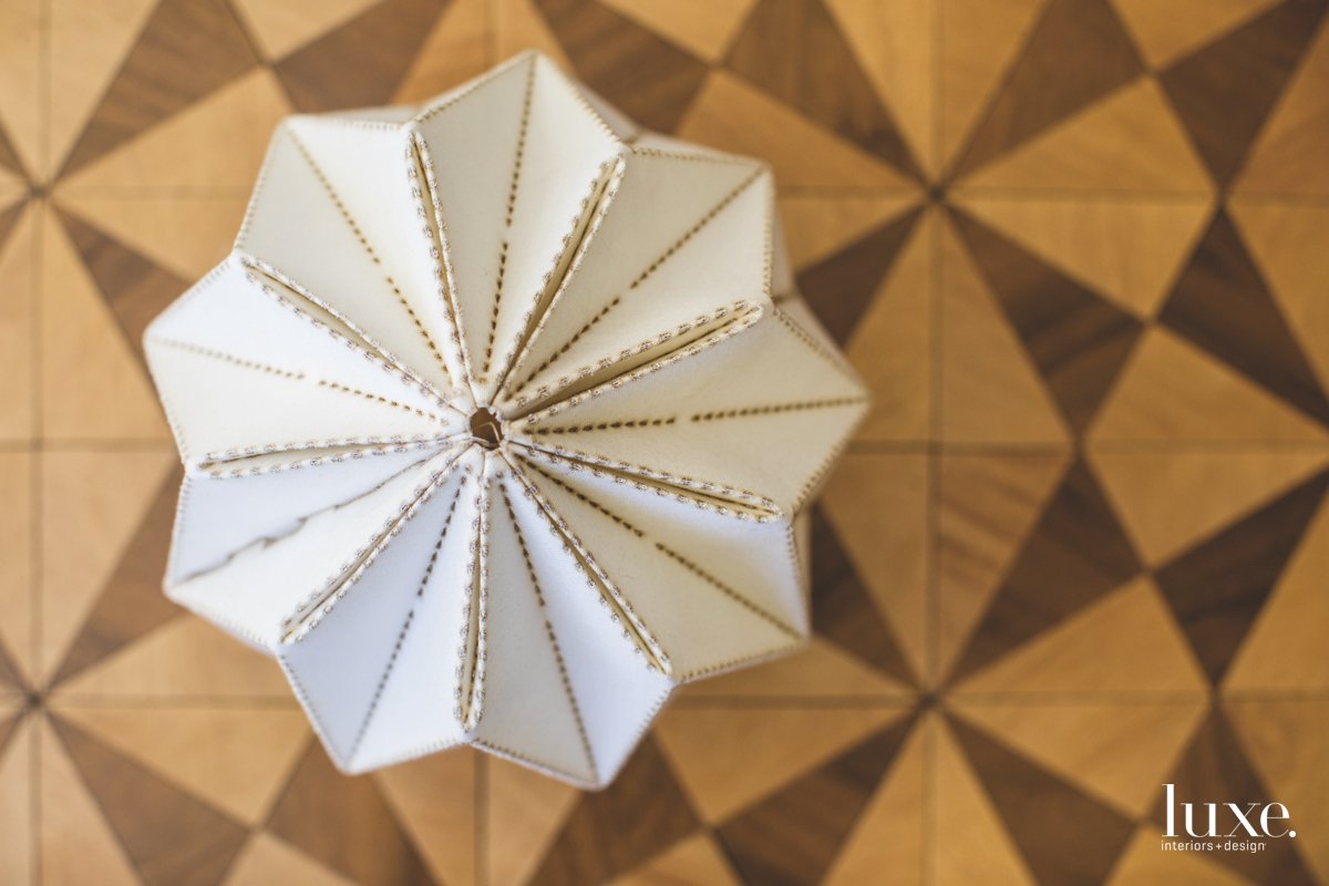 A close-up view of a light reveals the crisp craftsmanship of his designs.