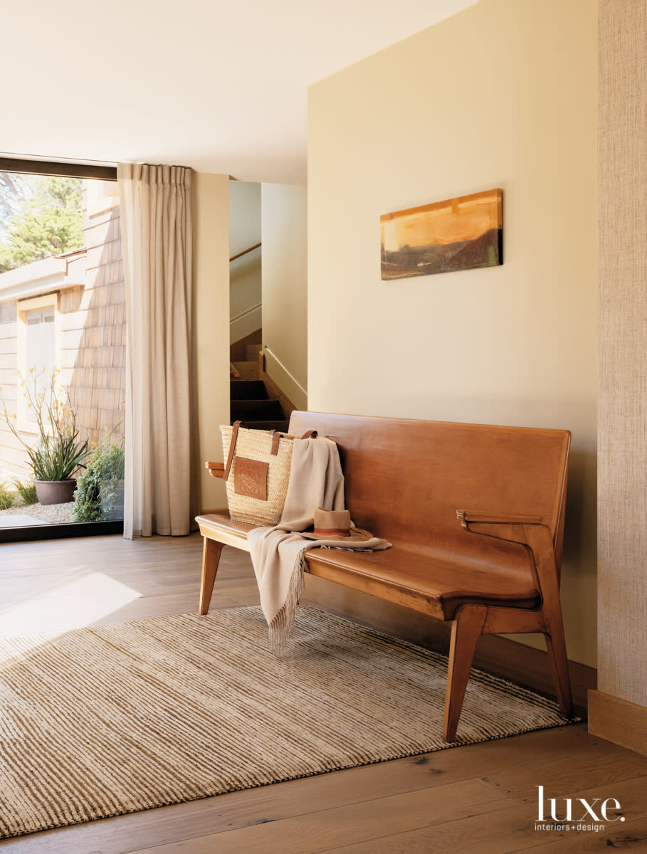 A bench sits in the entry of the home.
