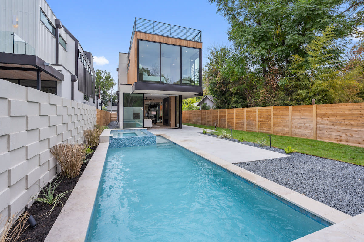 A contemporary house with a pool and deck, offering a perfect blend of style and relaxation.