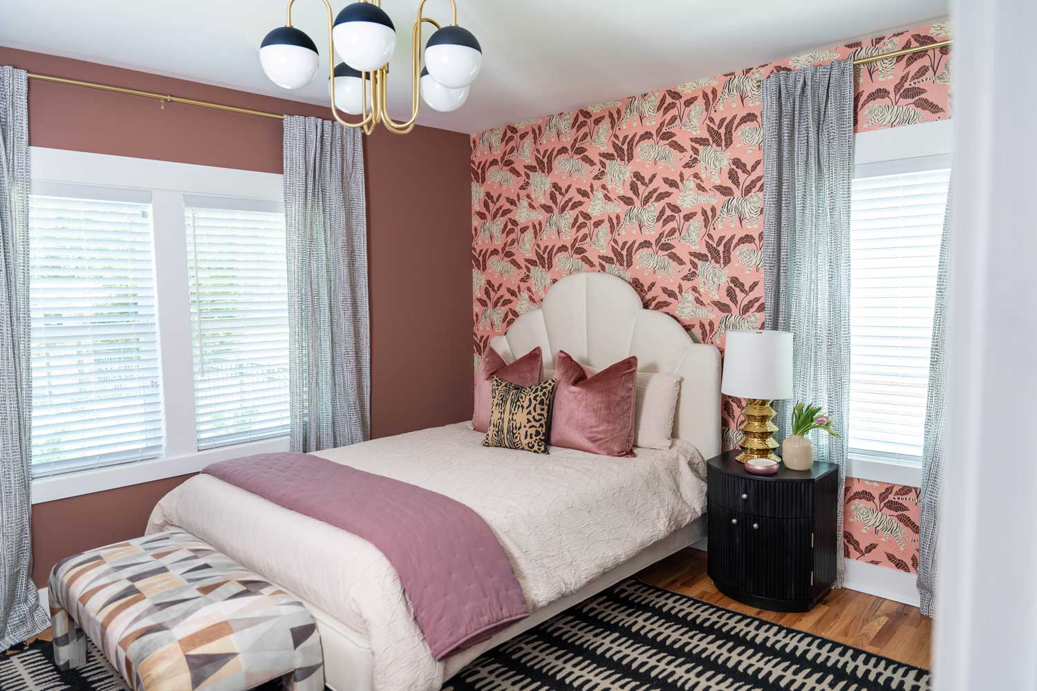 bedroom with white bed, pink runner, pillows and headboard