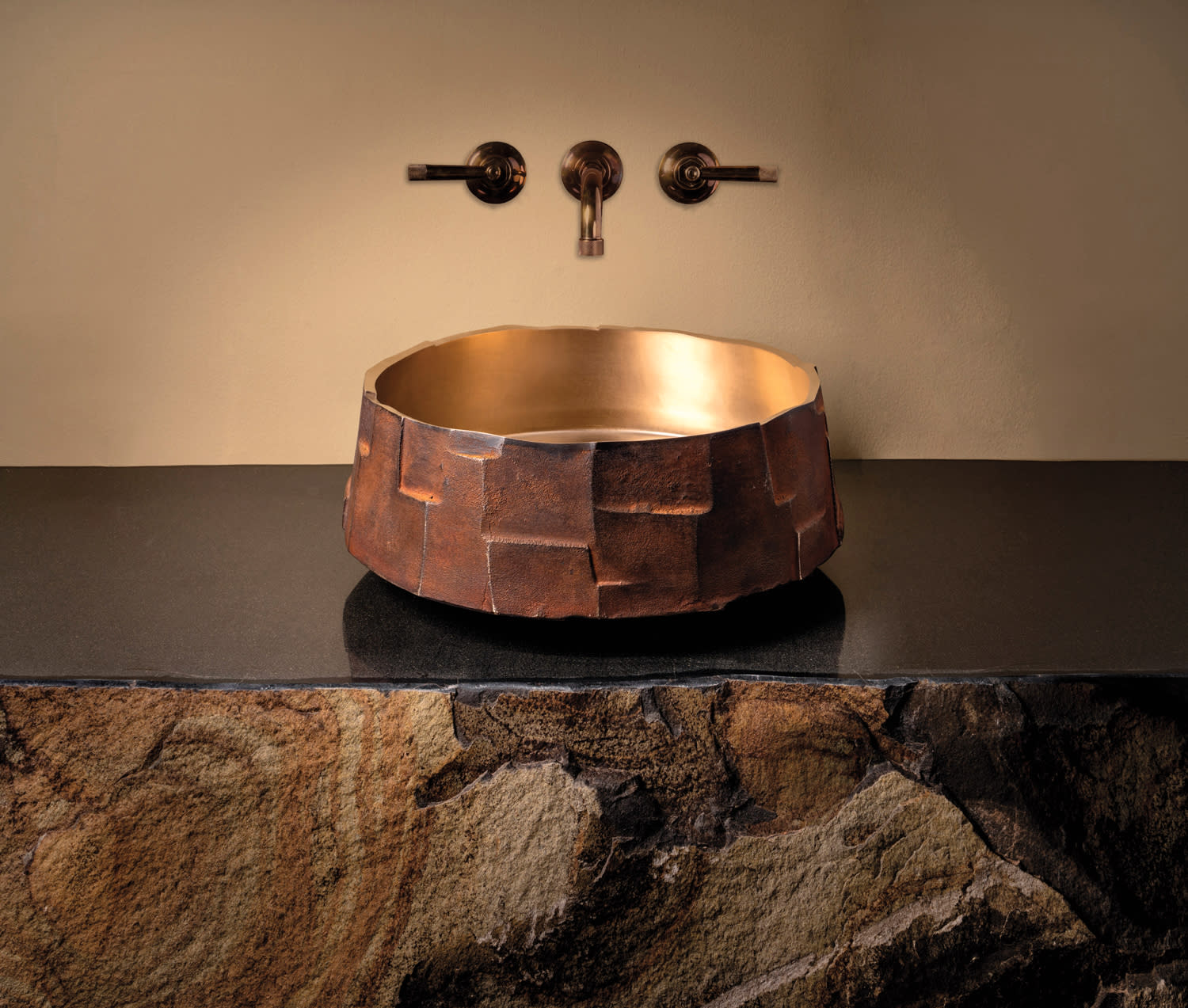 bronze bathroom sink with a patinated finish 