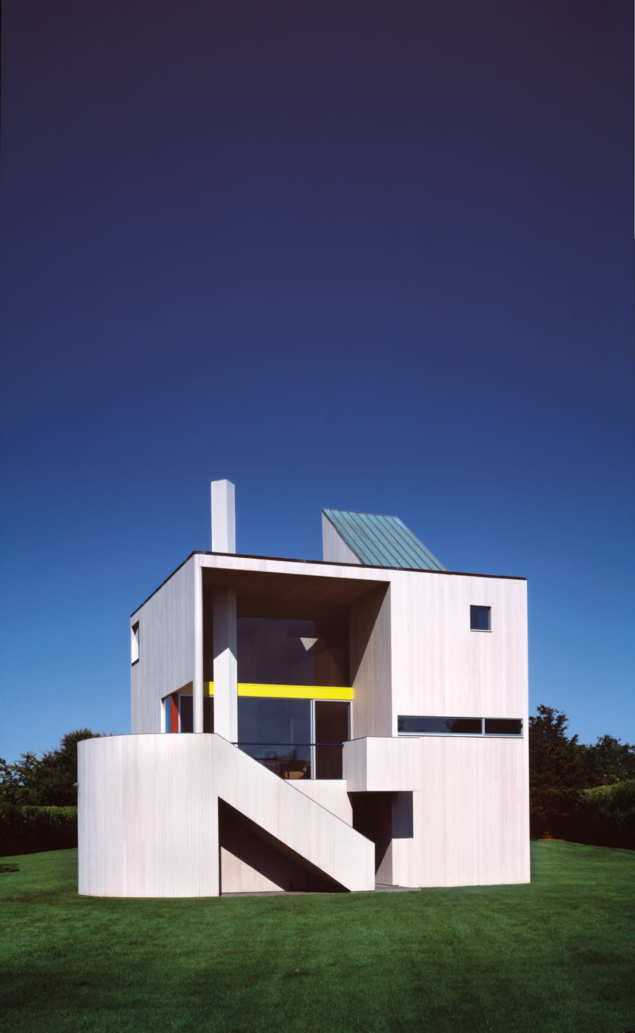 rectangular white building with blue walls in field