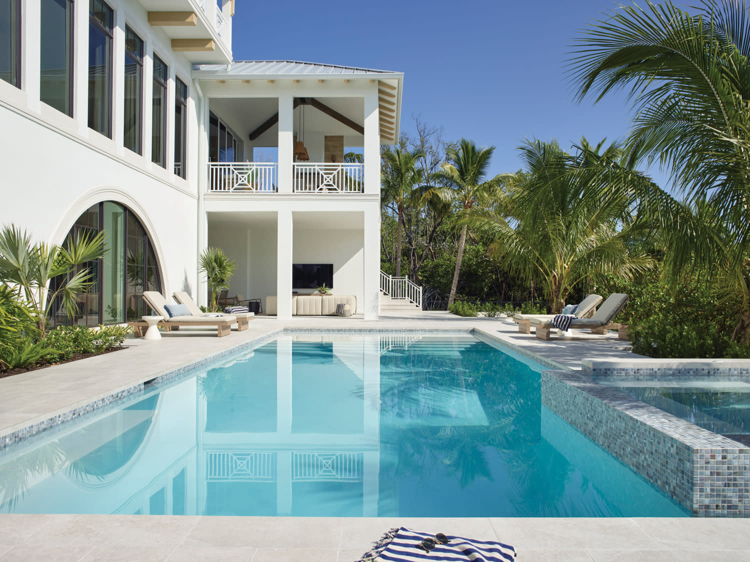 luxury pool outside of a white stucco exterior home in Bonita Springs, Florida