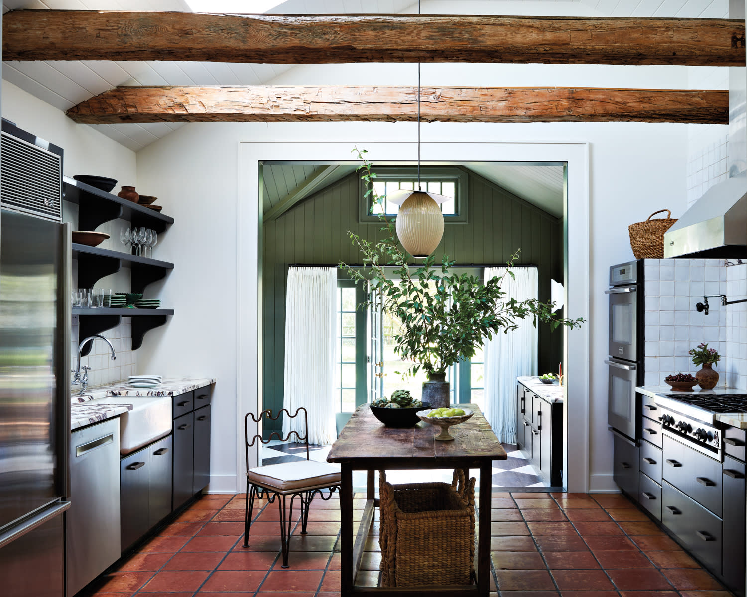 rustic farmhouse kitchen with wooden island table and hanging pendant