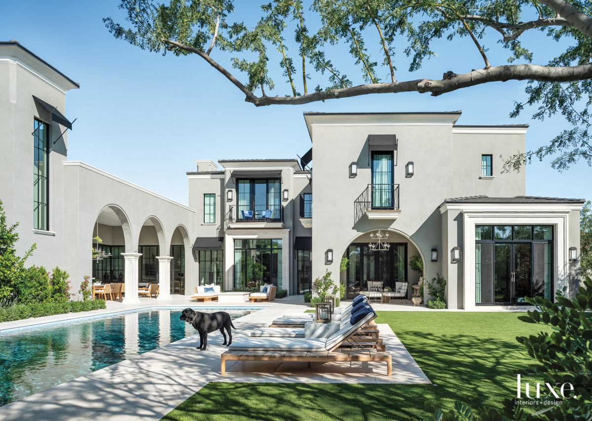 backyard pool with courtyard and lounge chairs