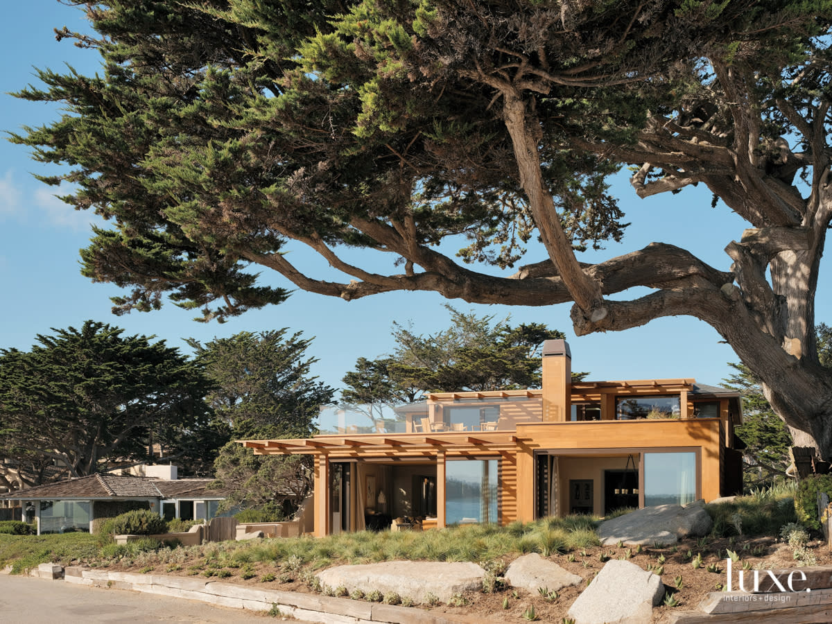 A modern, wood-clad home blends in with the landscape.