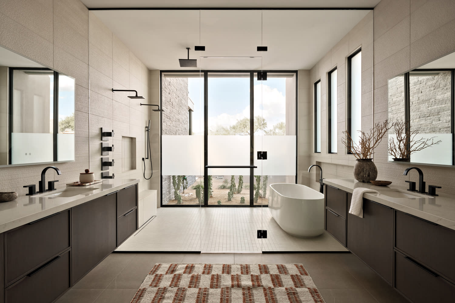 contemporary bathroom with double vanities covered in quartz countertops 