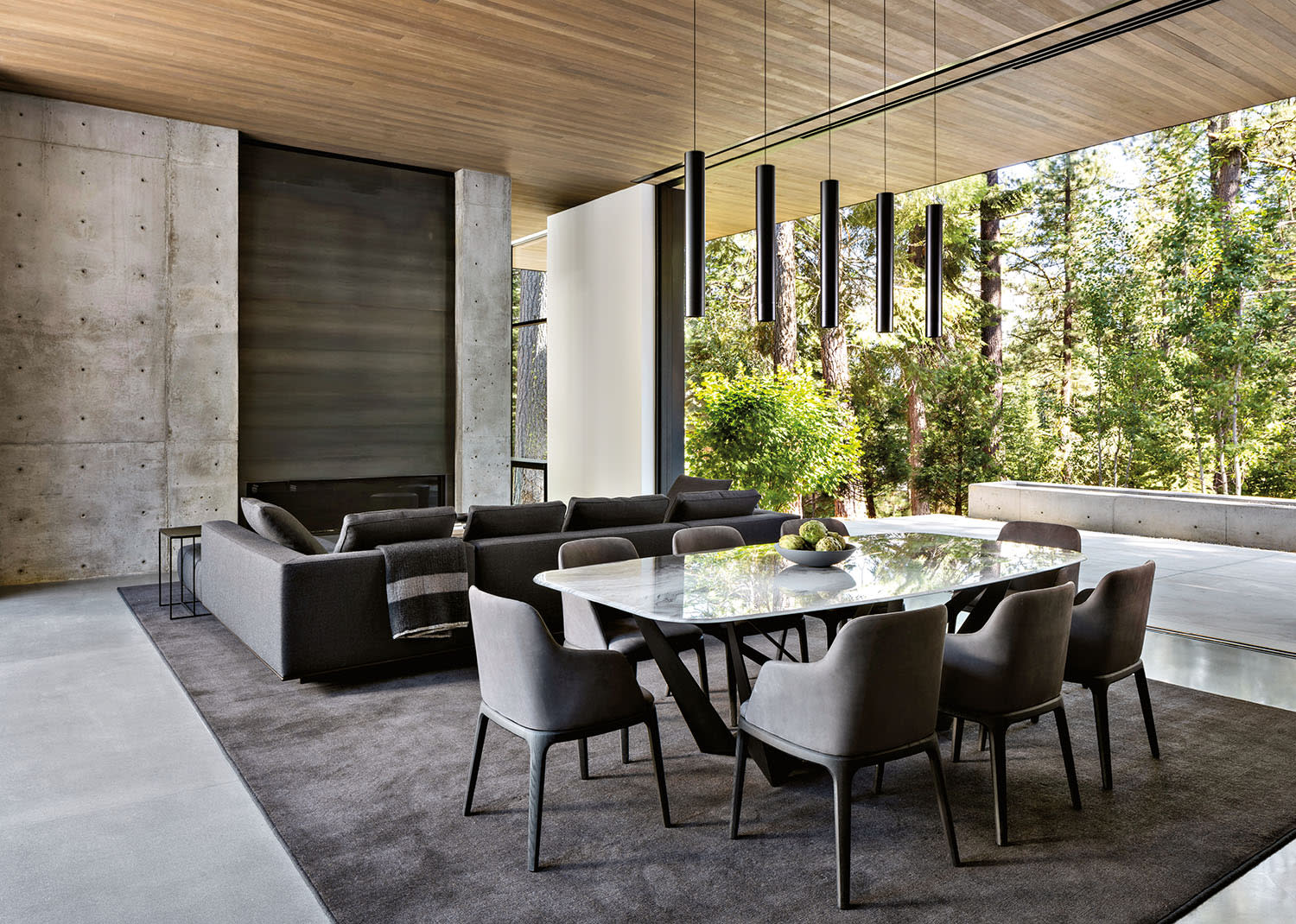 Modern open-concept dining and living room with large windows.