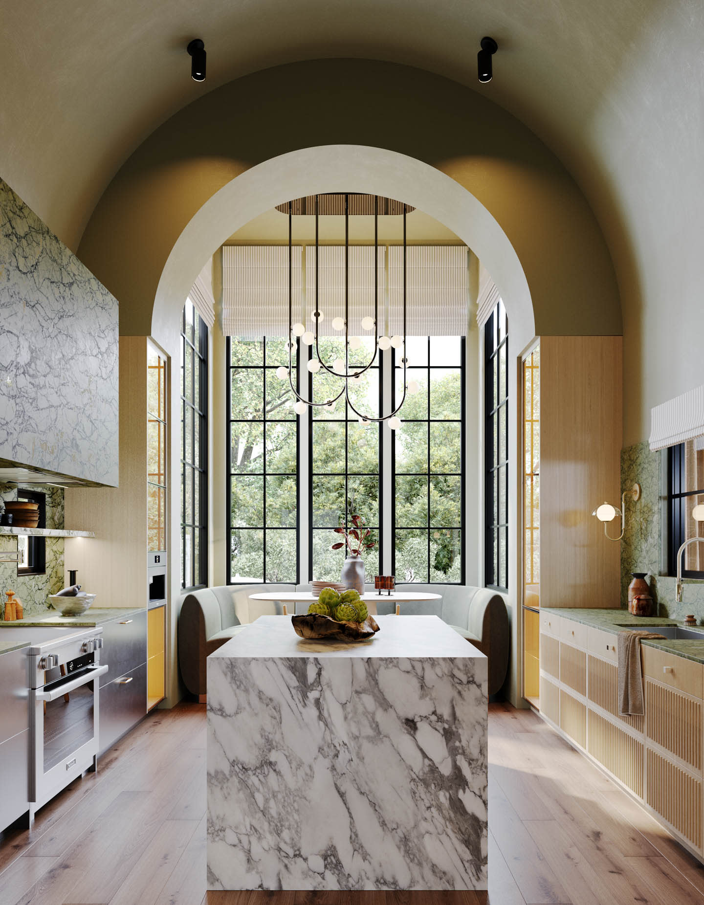 A modern kitchen with high arch ceilings features a marble island, sleek appliances, and large windows overlooking greenery. A chandelier adds elegance.