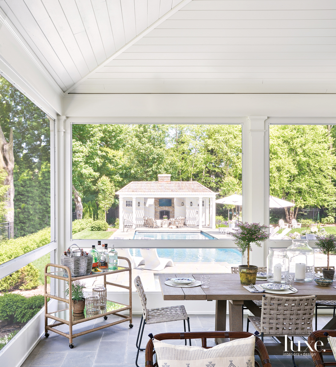 back porch seating area with pool view