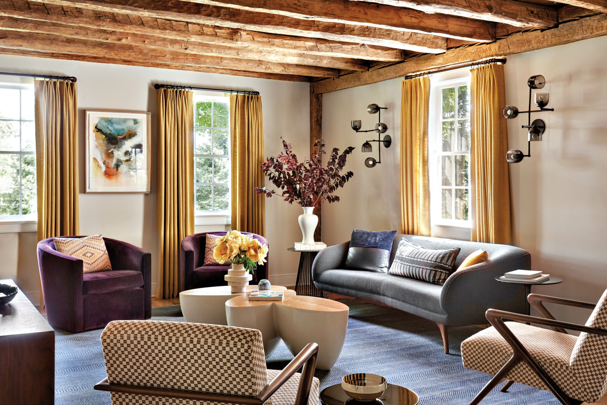 living room designed by Kathleen Walsh with grey sofa and exposed beams