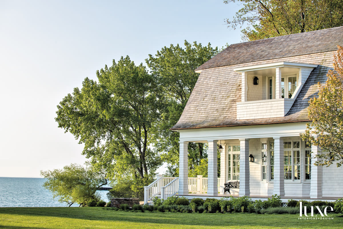 The outside of white shingle-style house on Lake Michigan.