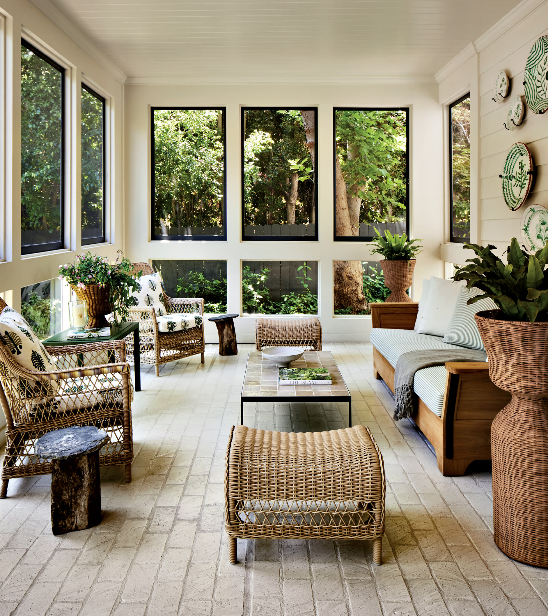 traditional screened-in porch with wicker furniture and a natural color palette