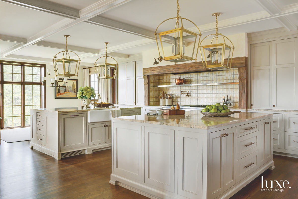 traditional kitchen neutral white cabinetry gold lanterns