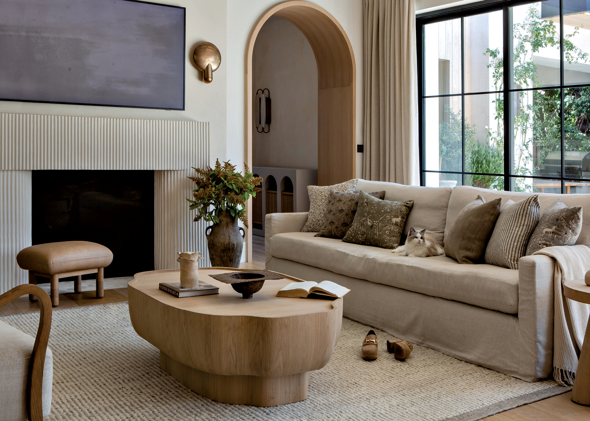 modern organic living room with an arched doorway