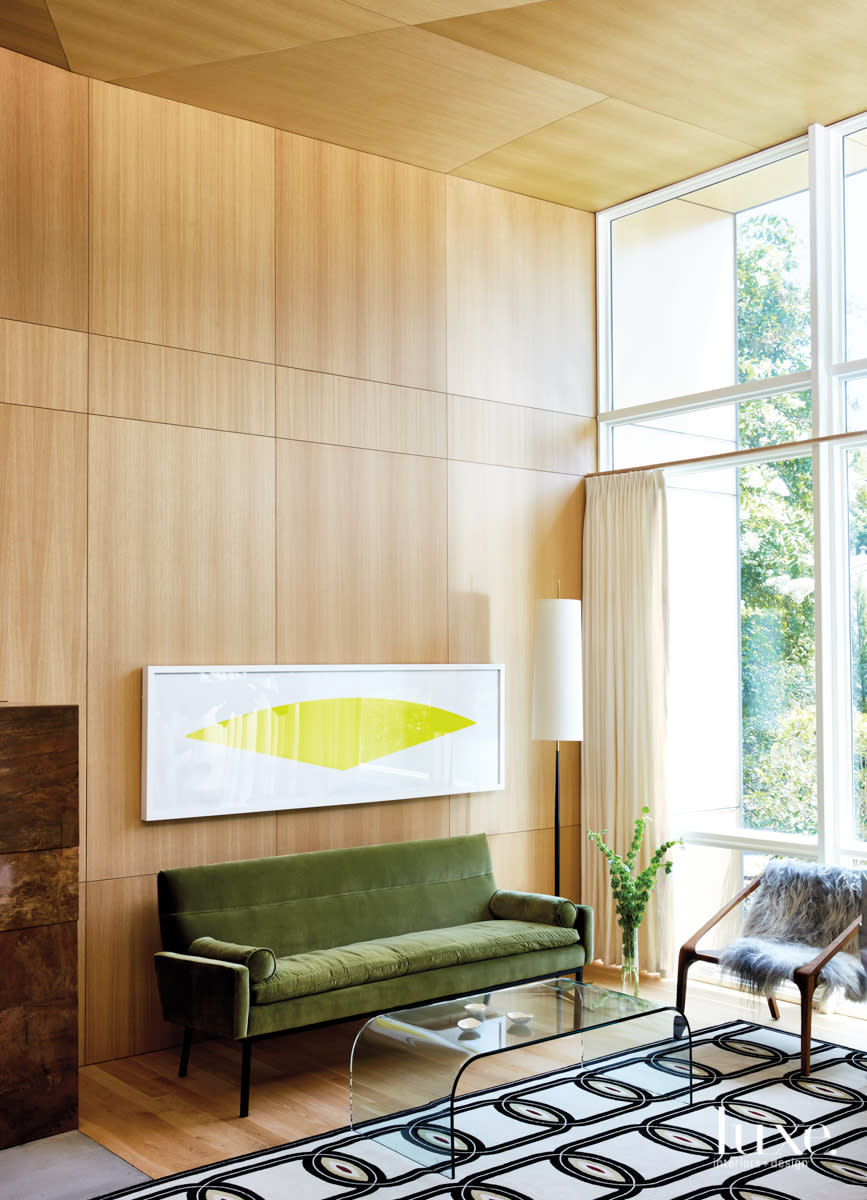 living room with modern wood paneling, midcentury furniture and a yellow Ellsworth Kelly print