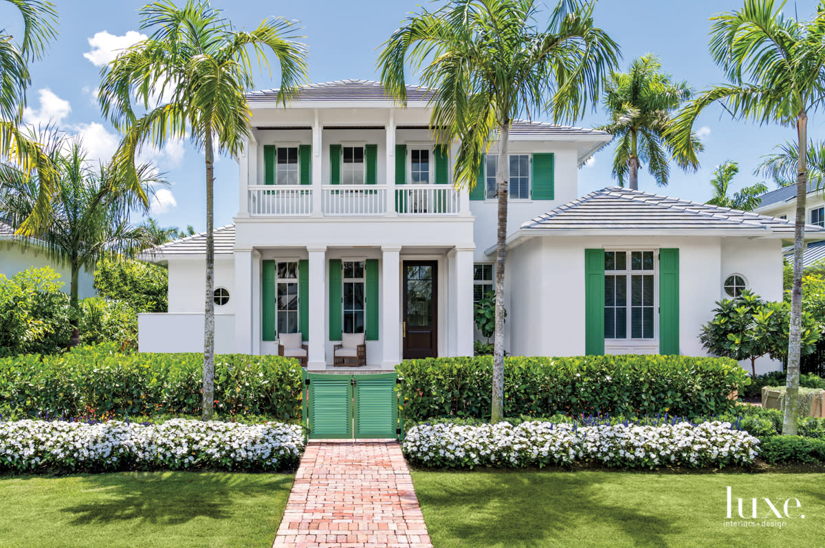 exterior of naples home from the front, white home with green shutters and balcony