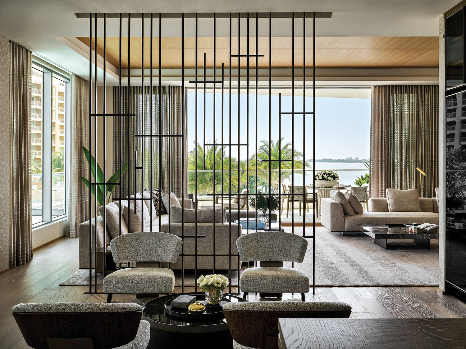 contemporary home lounge with a metal-screen partition defining the space 