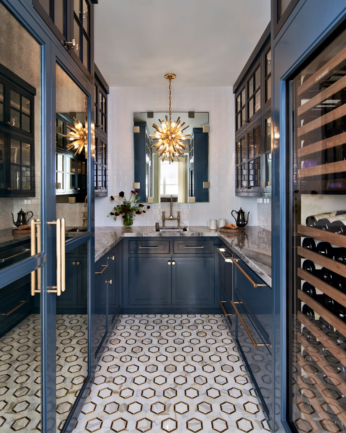 Art Deco-style pantry with a sputnik pendant and blue cabinetry