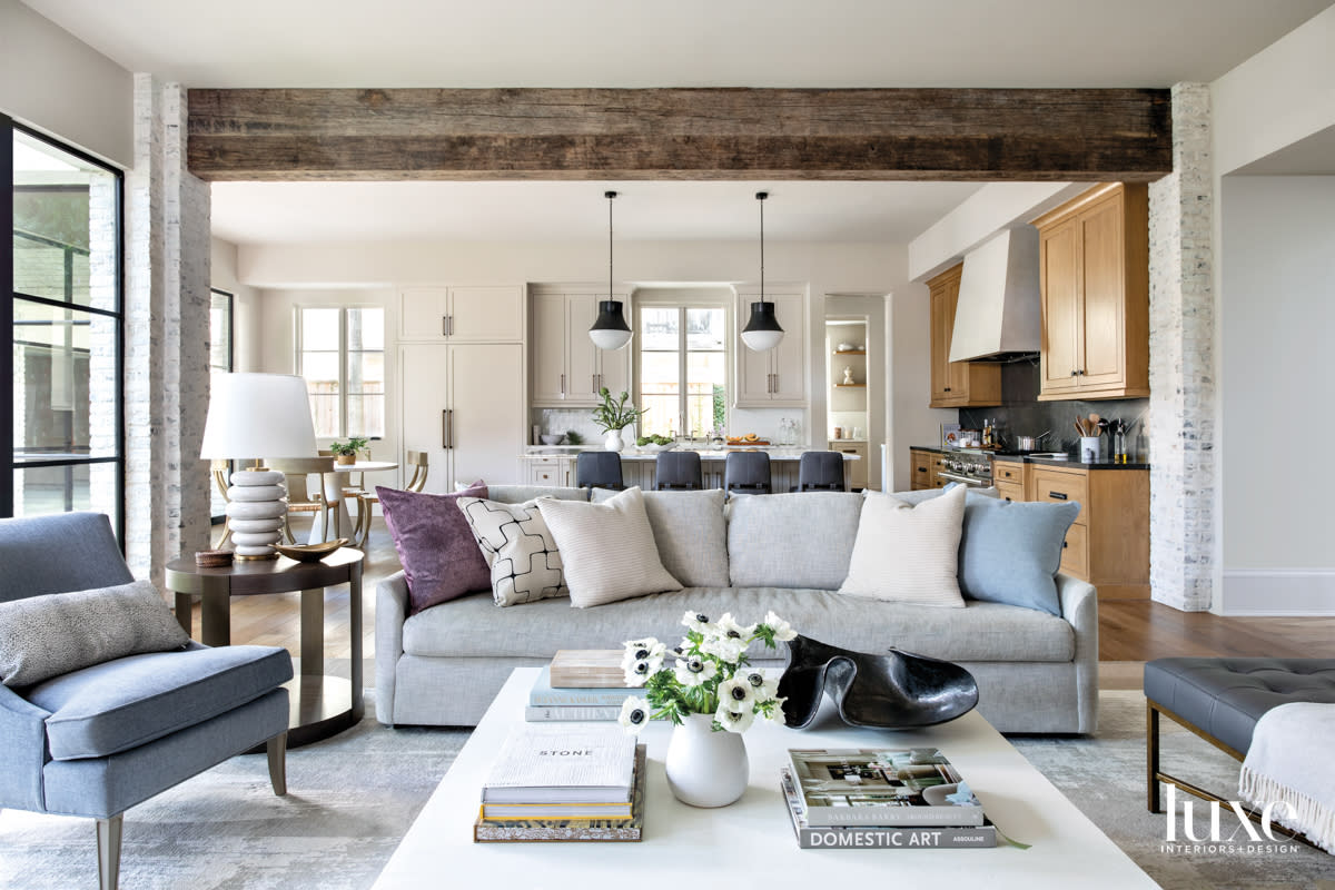 Family room off kitchen that features plush monochromatic seating.