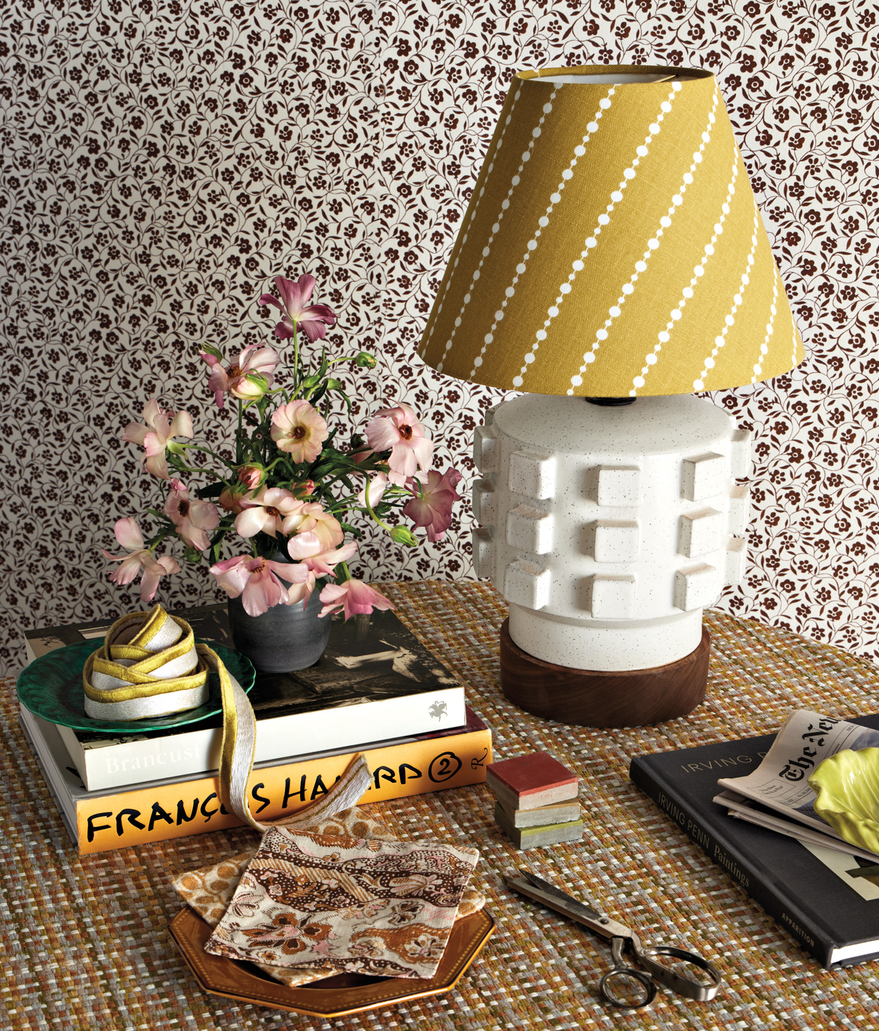 a small table lamp next to a stack of books