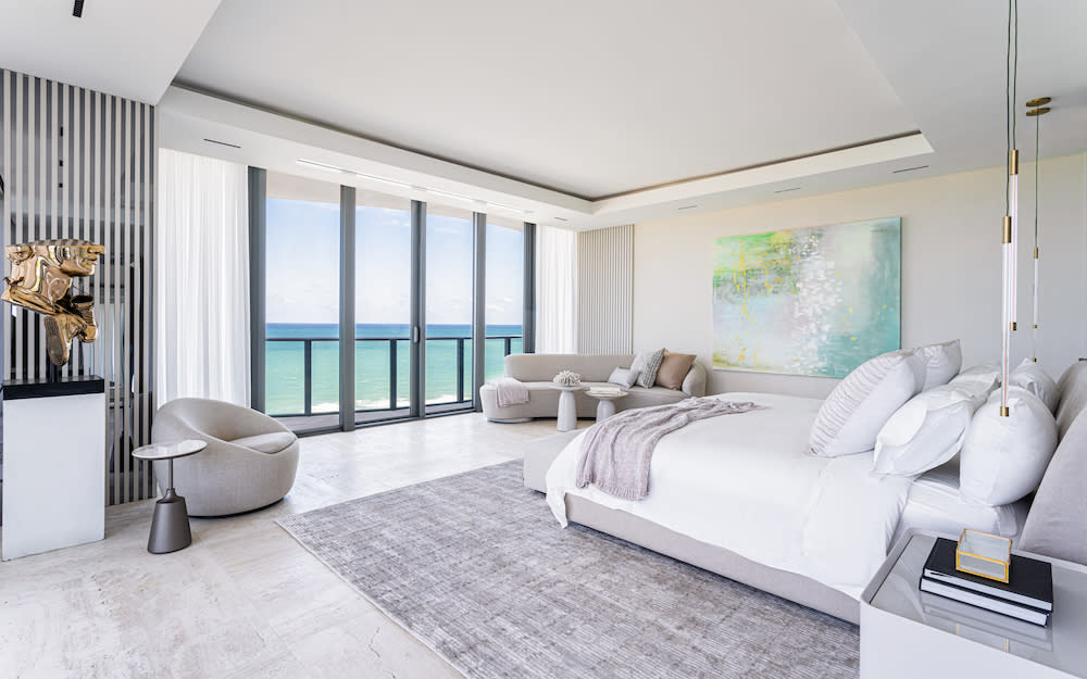 Bright bedroom with a spacious bed and breathtaking ocean views, creating a serene and inviting atmosphere.