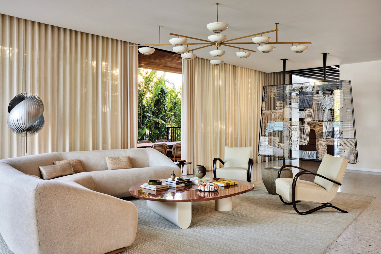 living room with white couches, drapes, coffee table and chandelier in home by Michael Edward Moirano