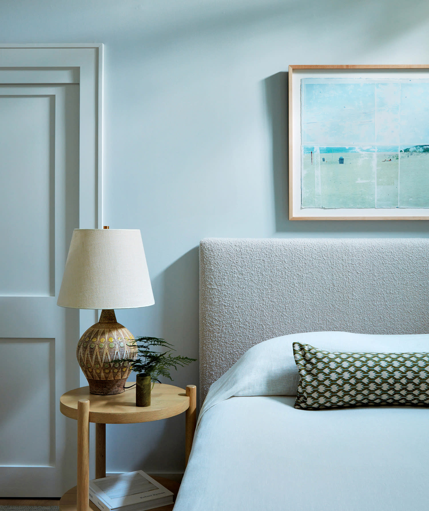 light blue bedroom with a Michael Souter painting